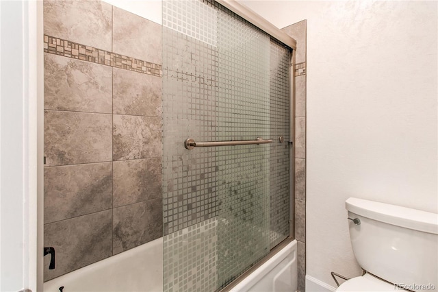 2790 S Wheeling Way, Aurora, CO 80014 - bathroom with toilet and bath / shower combo with glass door