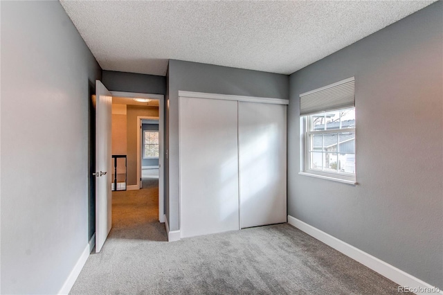 2790 S Wheeling Way, Aurora, CO 80014 - unfurnished bedroom featuring carpet flooring, a closet, and a textured ceiling