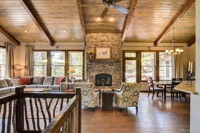 living room with ceiling fan with notable chandelier, hardwood / wood-style floors, wooden ceiling, a fireplace, and lofted ceiling with beams