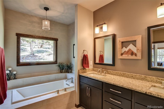 bathroom with tiled bath and double vanity