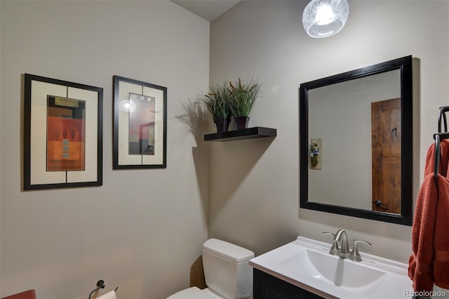 bathroom featuring toilet and vanity