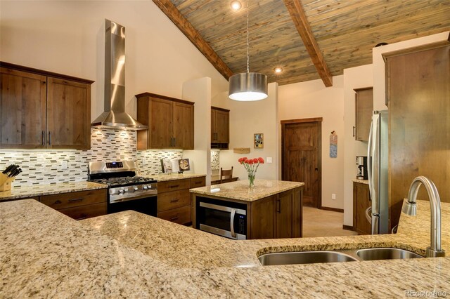 kitchen with wall chimney range hood, wooden ceiling, light stone countertops, and stainless steel appliances