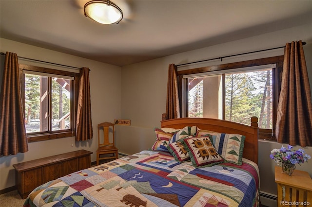 bedroom with a baseboard radiator and carpet