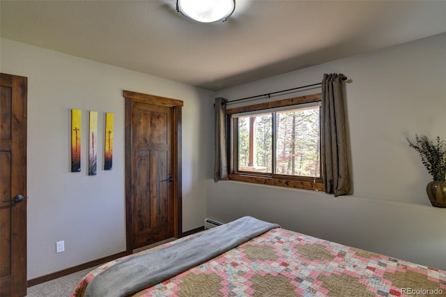 carpeted bedroom featuring a baseboard heating unit