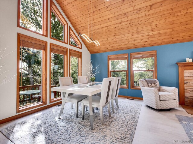385 Pine Dr, Fairplay, CO 80440 - dining area with visible vents, baseboards, wood finished floors, wooden ceiling, and high vaulted ceiling