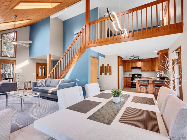 385 Pine Dr, Fairplay, CO 80440 - dining room with light wood-type flooring, stairway, a towering ceiling, and a ceiling fan