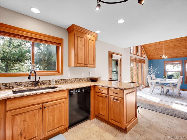385 Pine Dr, Fairplay, CO 80440 - kitchen with a peninsula, light stone counters, a sink, and black dishwasher