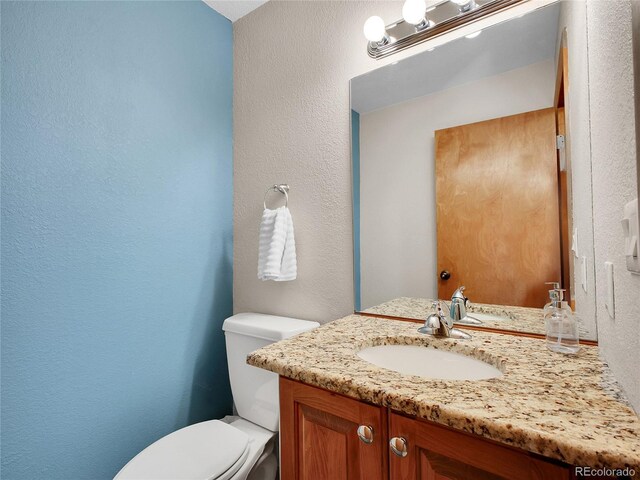 385 Pine Dr, Fairplay, CO 80440 - bathroom with a textured wall, toilet, and vanity