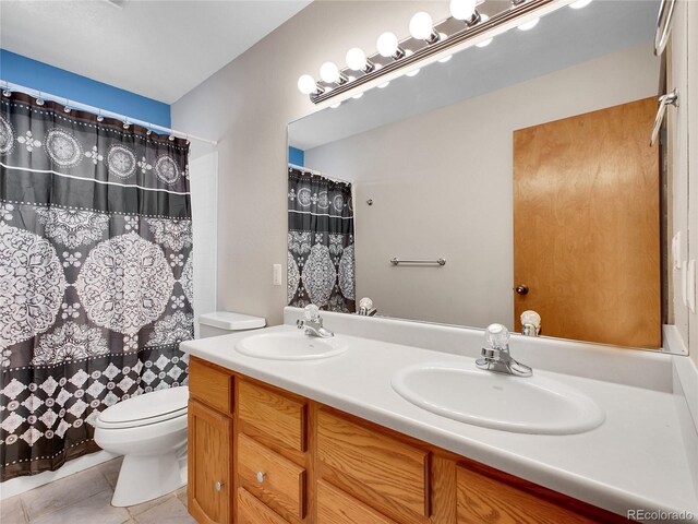 385 Pine Dr, Fairplay, CO 80440 - full bath featuring tile patterned flooring, double vanity, toilet, and a sink