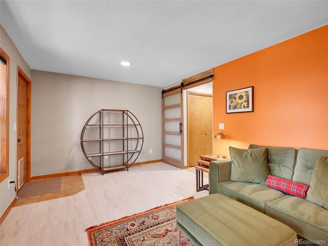 385 Pine Dr, Fairplay, CO 80440 - living room featuring a barn door, wood finished floors, baseboards, and recessed lighting