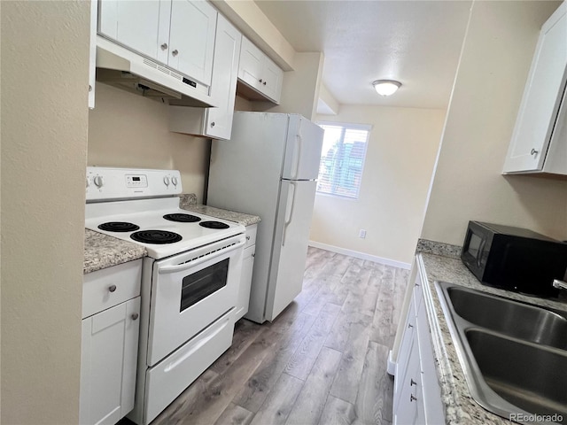 kitchen with light stone countertops, white cabinetry, sink, light hardwood / wood-style floors, and white appliances