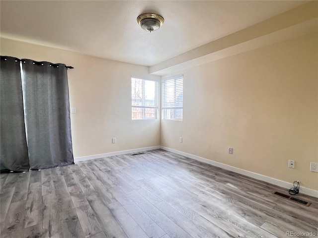 spare room featuring light wood-type flooring