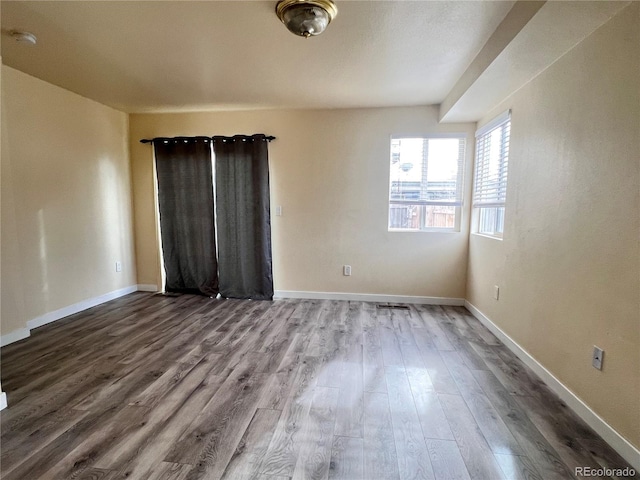 spare room with hardwood / wood-style flooring