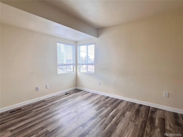 spare room with dark hardwood / wood-style floors