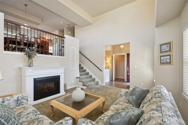 living room with carpet floors and a high ceiling