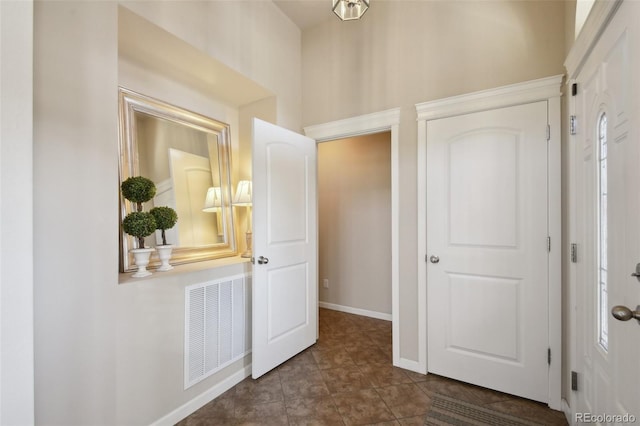 hall featuring dark tile patterned floors