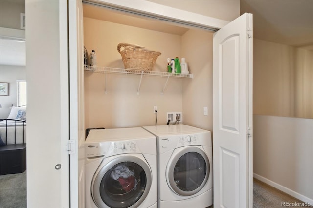 clothes washing area with carpet floors and separate washer and dryer