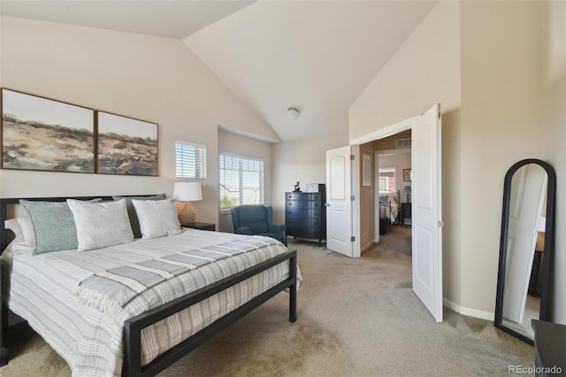 bedroom featuring light carpet and high vaulted ceiling