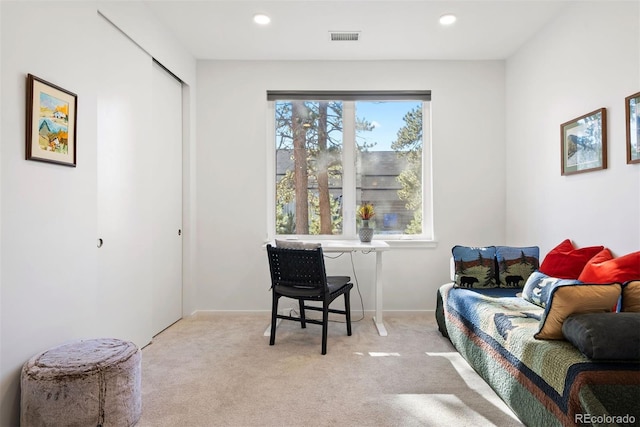 sitting room featuring light colored carpet