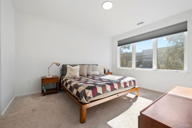 bedroom featuring light colored carpet