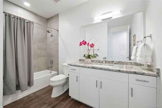 full bathroom featuring vanity, toilet, hardwood / wood-style flooring, and shower / bathtub combination with curtain