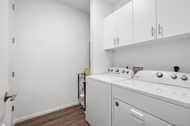 washroom featuring cabinets, independent washer and dryer, and dark hardwood / wood-style flooring