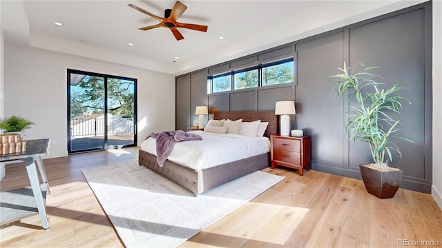 bedroom with access to exterior, ceiling fan, and light hardwood / wood-style floors