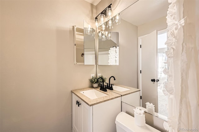 bathroom with toilet and vanity