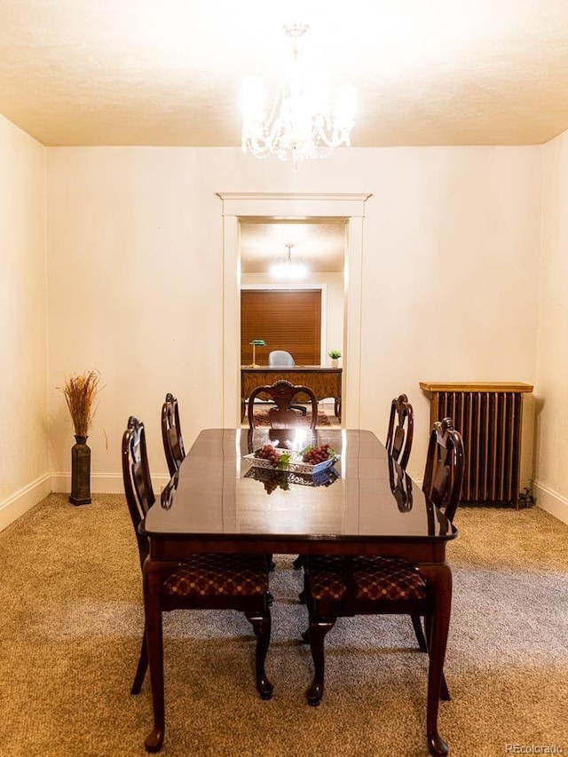 dining space with carpet flooring, radiator heating unit, and an inviting chandelier