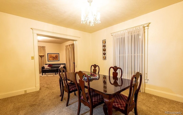 carpeted dining space featuring a notable chandelier