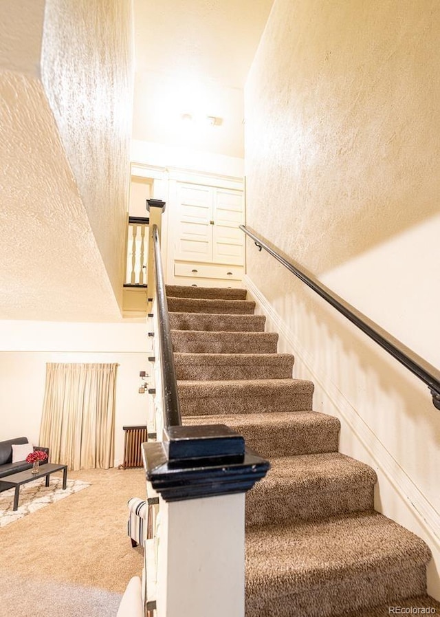 stairs featuring carpet