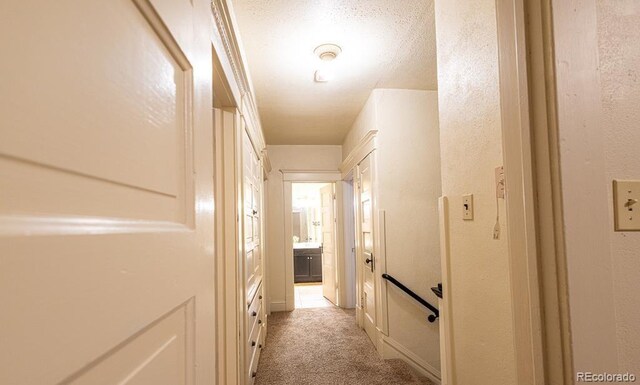 corridor featuring light colored carpet