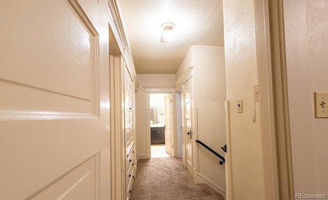 hallway featuring light colored carpet