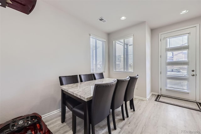 dining space with light hardwood / wood-style floors