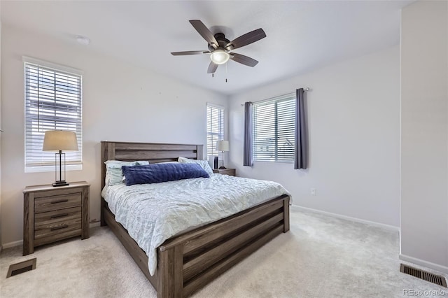 bedroom featuring light carpet and ceiling fan