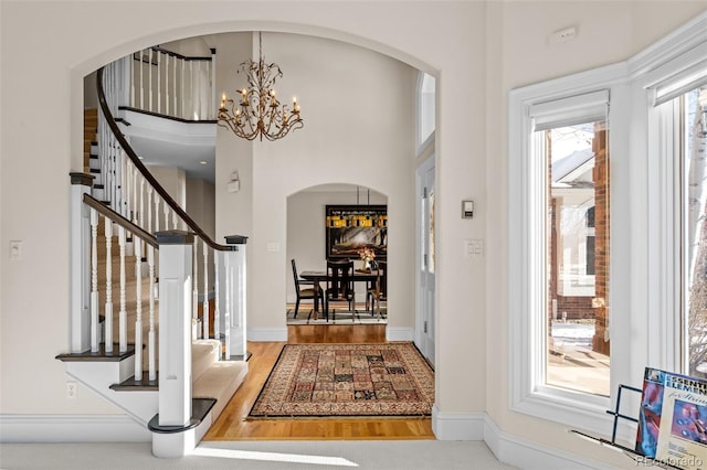 entrance foyer with hardwood / wood-style flooring and an inviting chandelier