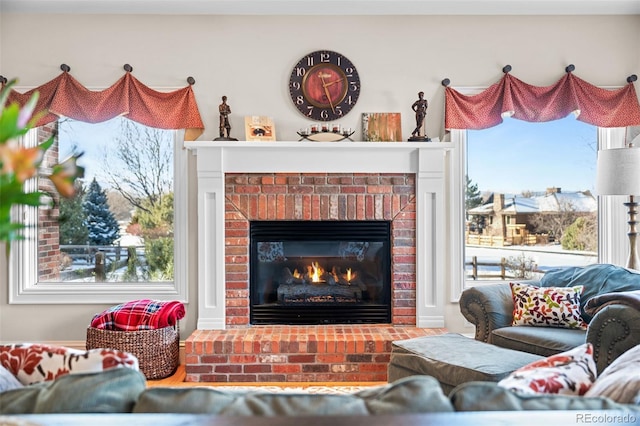 living room featuring a brick fireplace