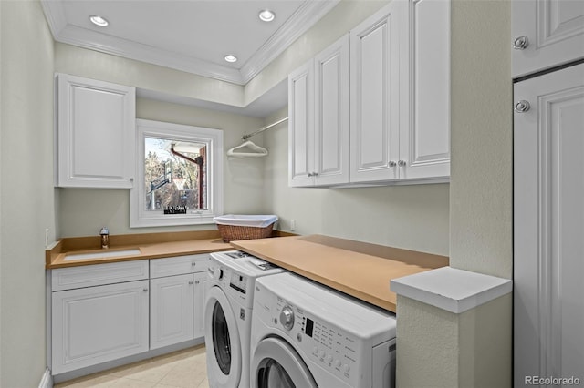 laundry area with sink, cabinets, light tile patterned floors, independent washer and dryer, and crown molding