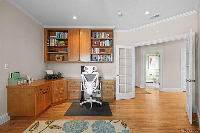 home office with built in desk, ornamental molding, light hardwood / wood-style floors, and french doors