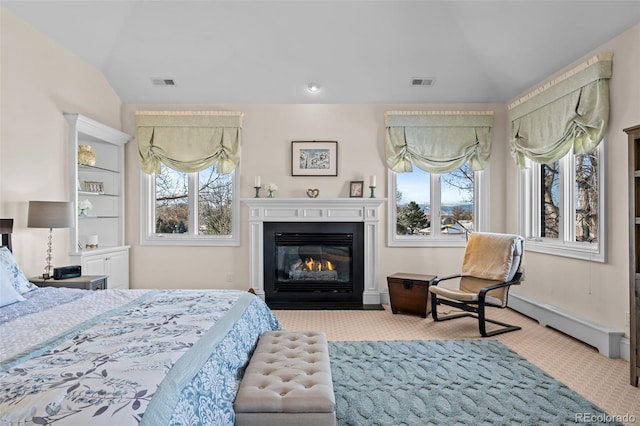 carpeted bedroom with lofted ceiling