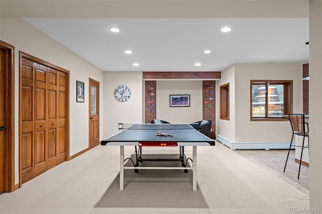 recreation room featuring a baseboard radiator and light colored carpet