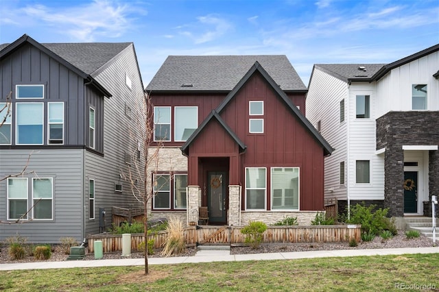 1929 W 165th Way, Broomfield, CO 80023 - view of front of home featuring board and batten siding, stone siding, and a fenced front yard