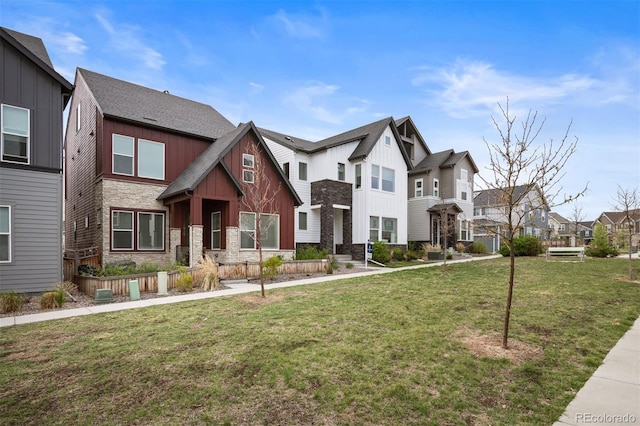 1929 W 165th Way, Broomfield, CO 80023 - view of front of house with board and batten siding, a residential view, stone siding, and a front yard