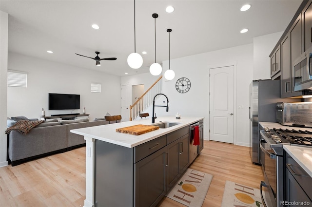 1929 W 165th Way, Broomfield, CO 80023 - kitchen featuring stainless steel appliances, a sink, light wood-type flooring, light countertops, and recessed lighting