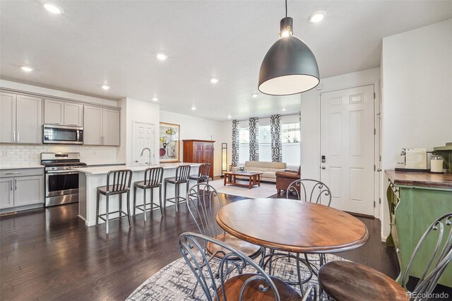 dining space with sink and dark hardwood / wood-style flooring