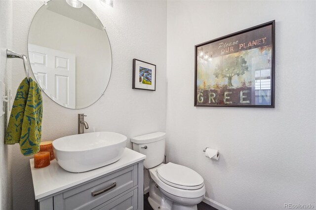 bathroom featuring vanity and toilet