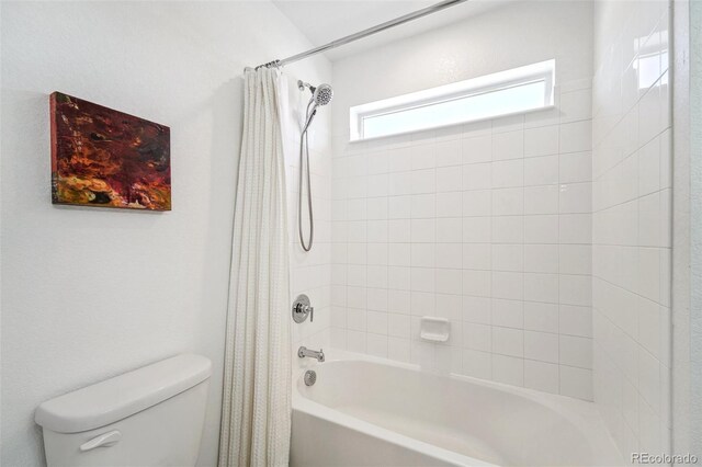 bathroom featuring shower / tub combo with curtain and toilet