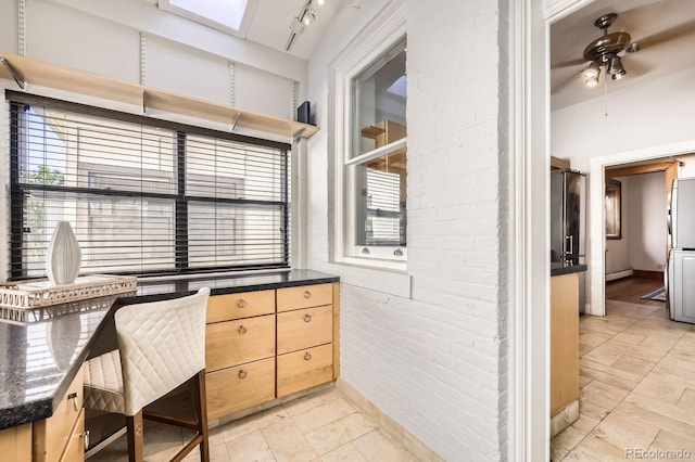 office space with a ceiling fan and a baseboard radiator