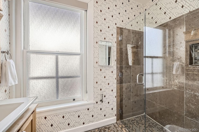 full bathroom with a shower stall and vanity