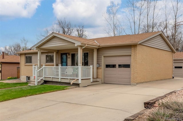 6905 Nelson St, Arvada, CO 80004 - ranch-style home with a front lawn, brick siding, a garage, a porch, and concrete driveway